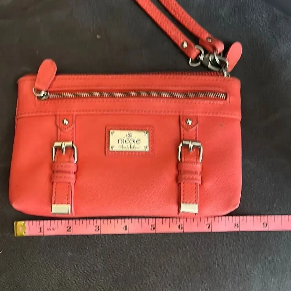 Nicole by Nicole Miller salmon colored Wristlet with Gold Details